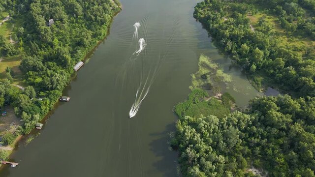 Aerial view from drone yachts and jet skis on water on river