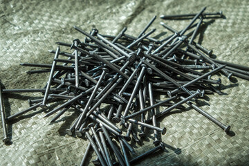 a pile of nails scattered on the building surface