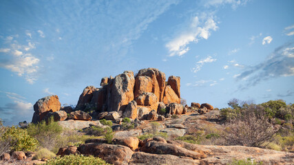 Rocky outcrop among other rocks under a blue sky in the Australian outback © wrightouthere