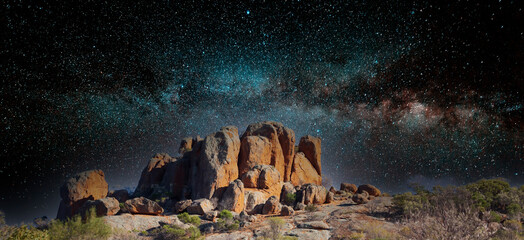 Merged image of a rocky outcrop among other rocks  in the Australian outback with an image of a...
