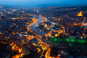 Picturesque general view from drone of Georgian city of Tbilisi on banks of Mtkvari River at spring...