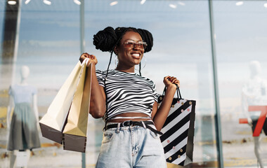 stylish african american woman, after shopping near the store, shopping on black friday