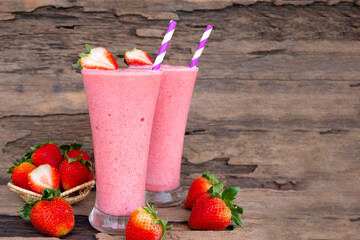 Strawberry yogurt fruit juice smoothie pink colorful fruit juice milkshake blend beverage healthy high protein the taste yummy In glass drink episode morning on wood background.
