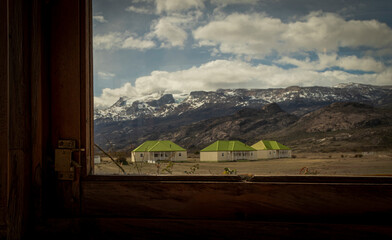 Houses in the middle of the mountains seen through the window