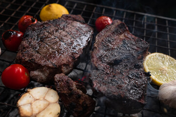 Vegetables and meat on the grill on hot coals with smoke
