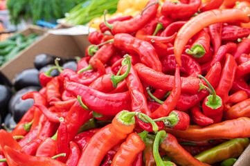 Red hot chilli peppers pattern texture background. Close up. Street vegetable market. Group of Red hot chilli peppers