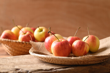 Fresh red apple fruit in a basket on wooden background, Still Life