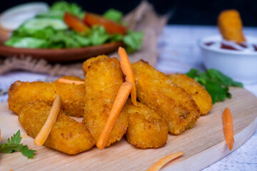 Vegetable Chicken Nugget, with chili sauce on cutting board decorated with tomatoes and lettuce