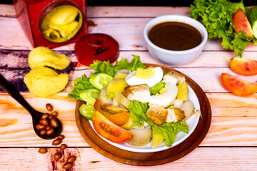 Close up view of Gado Gado, Indonesian traditional food with many vegetable. egg, tomato, cracker, lettuce, and potato
