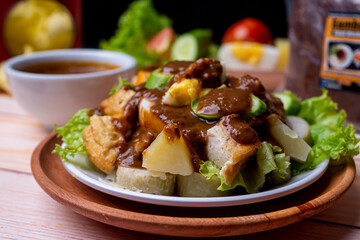 Close up view of Gado Gado, Indonesian traditional food with many vegetable. egg, tomato, cracker, fried peanut, and potato
