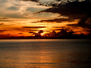 Sunrise over the ocean with unusual cloudscape. Still water. no waves, no people, copy space. Thailand, Koh Samui.