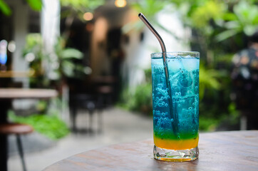 Blue Ocean drink with chia seeds and mint in the outdoor cafe on a sunny day