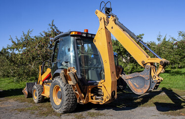 Excavator Tractor in an Apple Orchard, Auteuil, Laval, Quebec, Canada