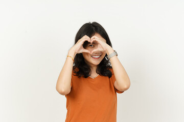 Beautiful Asian Woman Wearing Orange Color T-Shirt make and showing love heart hand sign Isolated On White Background