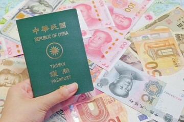 A man or woman take a passport. Background are different countries' banknotes, include renminbi, US dollars, Japanese yen, and Euros. Words on passport are 