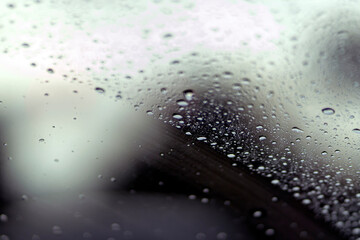 Shot from inside of a vehicle looking through the windshield while passing through traffic during a storm