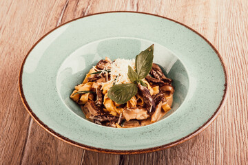 italian pasta with meat sauce in a plate on a wooden background top view