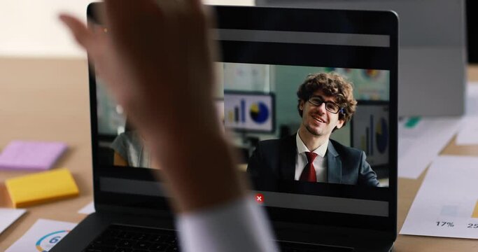 Online job and work assignment idea, a male audience watching laptop computer screen and listen to businessman and businesswoman executive speaking and explaining about business information.