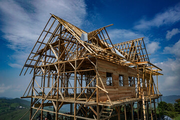 Fototapeta na wymiar In progress construction of a wooden house