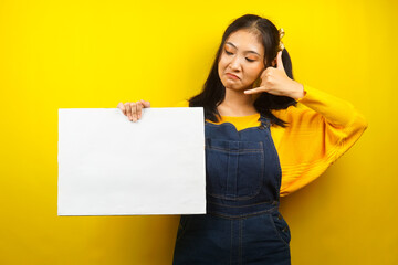 Fototapeta na wymiar Pretty and cute young woman holding blank empty banner, placard, white board, blank sign board, white advertisement board, presenting something in copy space, promotion