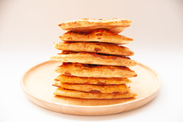 stack of pizza on wood plate and white background