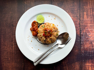 Close up canned fish fried rice Served on a large plate Put on the wood floor ,view from above ,Ready to eat
