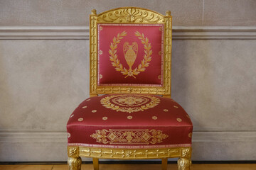 Elegant, oppulent and antique furniture with wood inlays and gold plated ornaments marble wall...