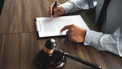 Legal counsel presents to the client a signed contract with gavel and legal law. justice and lawyer...