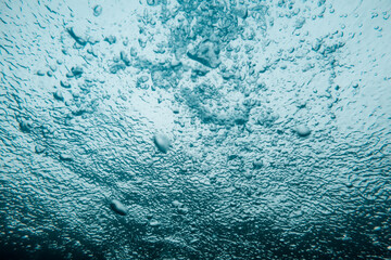 Underwater View of Bubbles In Deep Blue Ocean. Close Up Water. Background