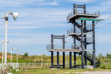 Multilevel observation tower under blue cloudy sky