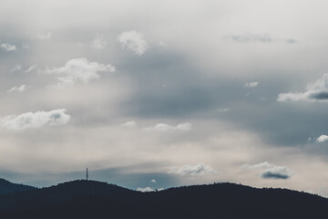 beautiful contrasty clouds formation coming and going across a stormy sky over the mountains of Tasmania