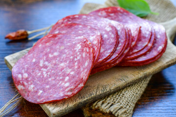 Slices Of  Traditional Italian antipasti  salami on a wooden  cutting board