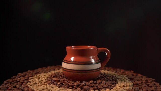 Pouring a Cup of coffee on a table in slow motion with coffee beans 