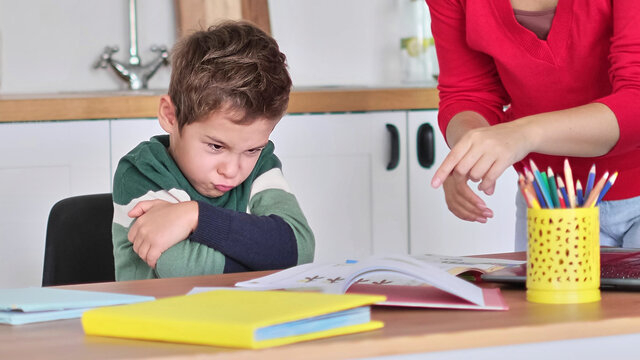 angry serious mum lecturing lazy unmotivated schoolboy, children education problem, parent and child conflict. Stressed mother and son frustrated over failure homework.