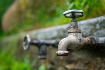 Vintage garden water tap. Photo with blurred backhround.