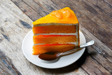 Orange sponge cake on wooden table