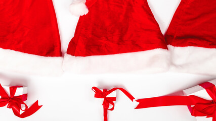 Composition with Christmas decorations. Santa Claus red hat with gift box