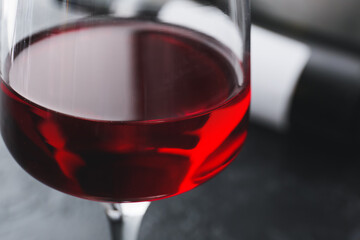 Glass of red wine on dark background, closeup