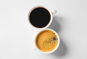 Cups of coffee on light background