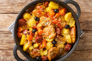 Chinese Portuguese style chicken stew with chorizo vegetables in coconut curry close-up in a pan on the table. horizontal top view from above