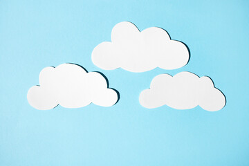 Clouds of white paper on a blue background. Flat lay, place for text.