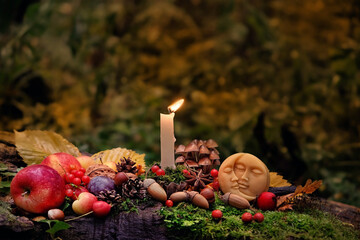 Moon amulet, candle, autumn leaves, fruits, berries, nuts in mysterious forest. Wiccan altar for Mabon sabbat. autumn equinox holiday. Witchcraft, esoteric spiritual ritual - obrazy, fototapety, plakaty