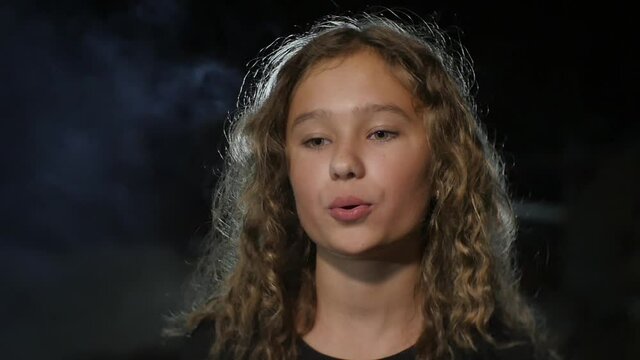 Girl Exhales Smoke
