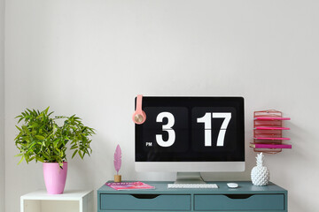 Stylish workplace with modern computer and decor near white wall
