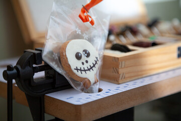 Round cookie mask for Halloween stands next to vise