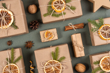 Christmas or New Year's composition. Boxes decorated with craft paper, dried oranges, spruce branches and natural decor. Concept Zero waste, eco friendly Merry Christmas. Top view Flat lay