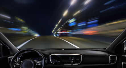 Obraz na płótnie Canvas View from a car driving along a night city street.