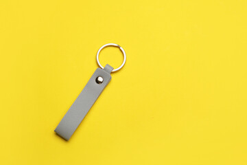 Leather keychain on color background