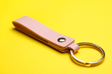 Leather keychain on color background, closeup