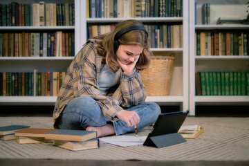 Teenage girl doing homework at a desk in her bedroom. teen girl school student write notes watch video online webinar learn on laptop. distance elearning course video conference pc call.
